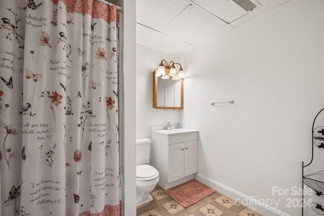 bathroom with vanity, curtained shower, toilet, and tile patterned flooring