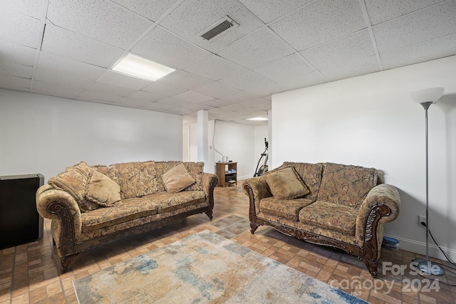 living room with a paneled ceiling