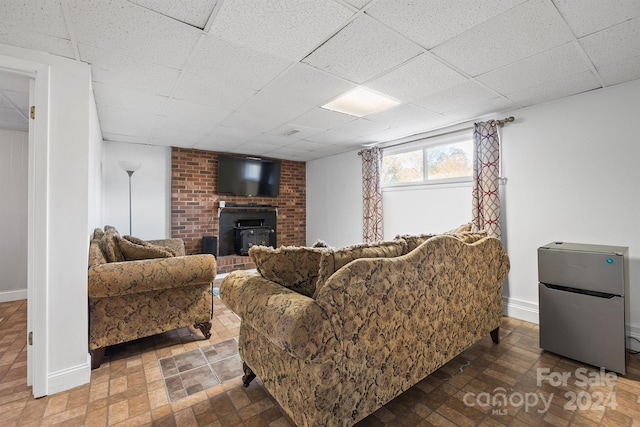 living room featuring a paneled ceiling