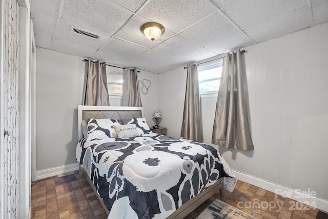 bedroom with a paneled ceiling