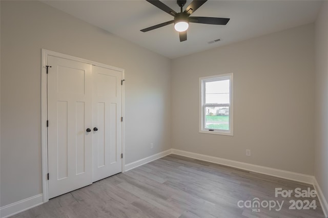 spare room featuring ceiling fan and light wood-type flooring