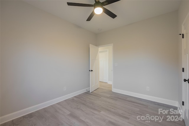 empty room with ceiling fan and light wood-type flooring