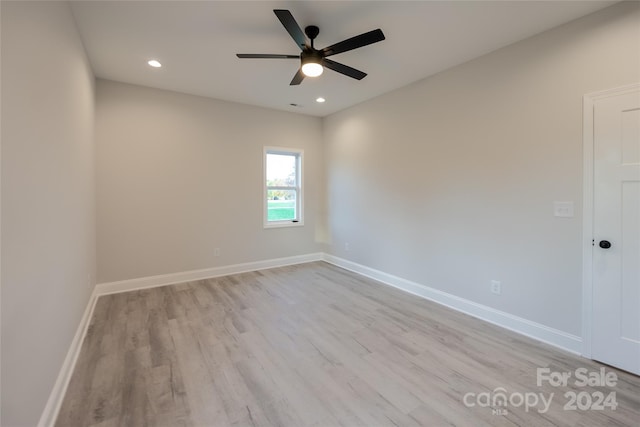 spare room with ceiling fan and light wood-type flooring