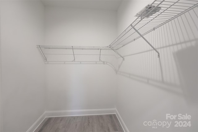 spacious closet featuring hardwood / wood-style floors