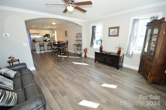 living room featuring crown molding, hardwood / wood-style flooring, and ceiling fan