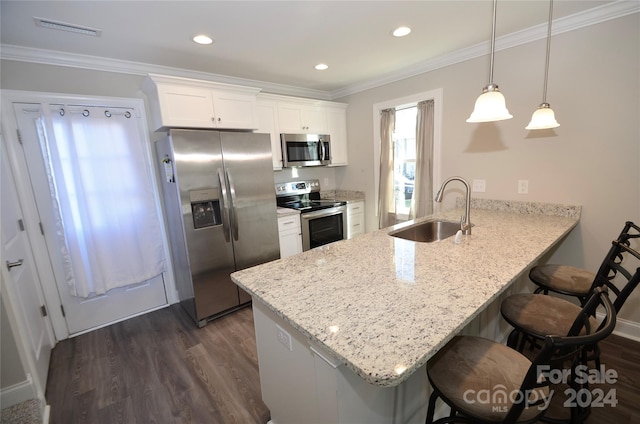 kitchen featuring kitchen peninsula, sink, white cabinetry, appliances with stainless steel finishes, and dark hardwood / wood-style flooring