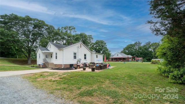 view of side of property with a lawn and an outdoor hangout area