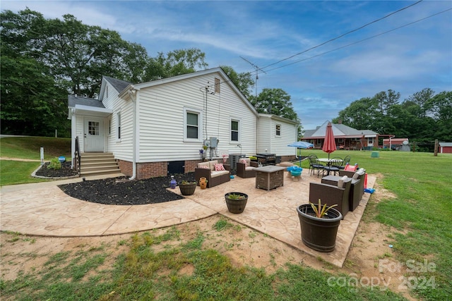 rear view of property with a patio area, outdoor lounge area, and a yard