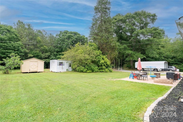 view of yard with a patio and a storage unit