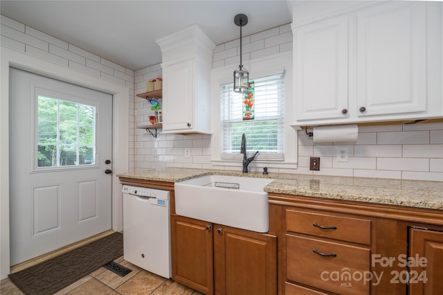 416 W Main St, Mooresboro, NC 28114 - kitchen with white dishwasher, a sink, white cabinets, hanging light fixtures, and backsplash
