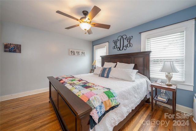 bedroom featuring ceiling fan and dark hardwood / wood-style flooring