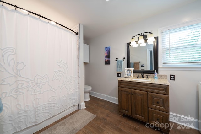 bathroom with vanity, hardwood / wood-style floors, toilet, and a shower with shower curtain