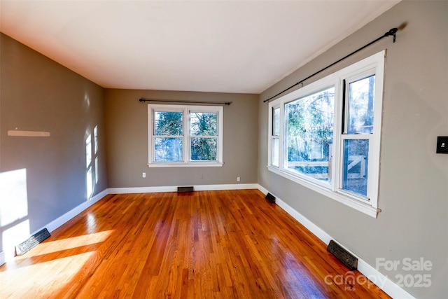 unfurnished room with wood-type flooring