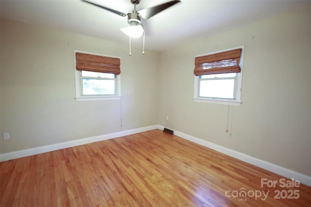 unfurnished room featuring light hardwood / wood-style floors, plenty of natural light, and ceiling fan