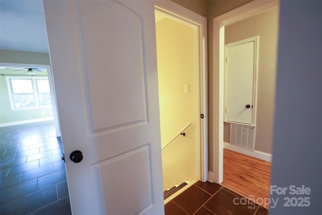 corridor with dark tile patterned flooring