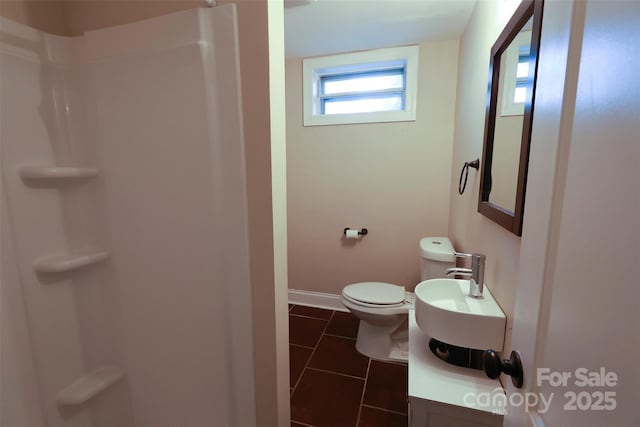 bathroom featuring a shower, tile patterned flooring, vanity, and toilet