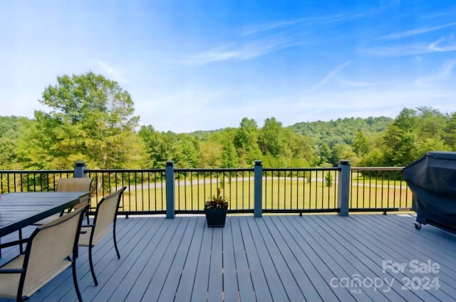 wooden deck featuring a grill