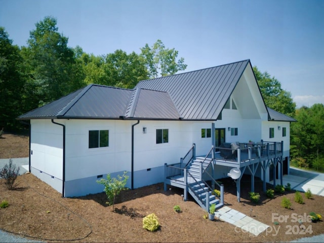 rear view of house with a wooden deck