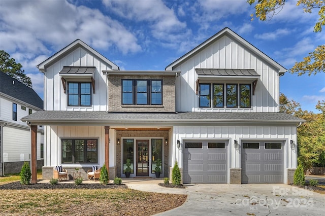 modern farmhouse with a garage and covered porch