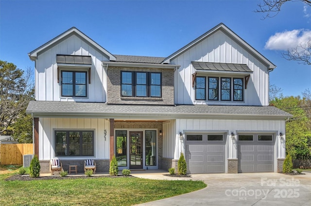 571 Lyttleton Dr, Charlotte, NC 28211 - modern farmhouse with board and batten siding, brick siding, fence, and an attached garage
