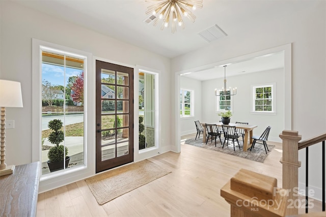 571 Lyttleton Dr, Charlotte, NC 28211 - entrance foyer with light wood-style flooring, a healthy amount of sunlight, a chandelier, and visible vents