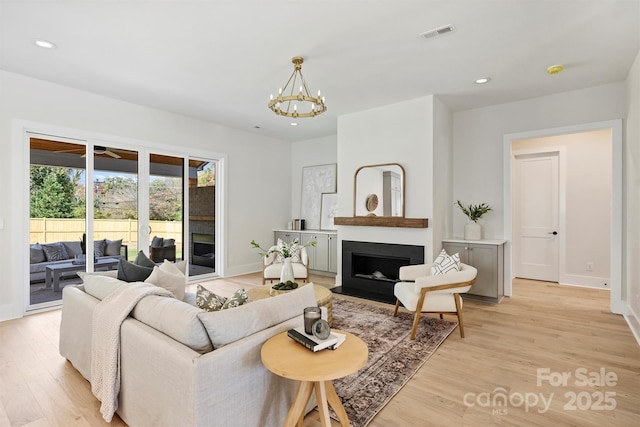 571 Lyttleton Dr, Charlotte, NC 28211 - living area featuring light wood finished floors, a notable chandelier, and recessed lighting
