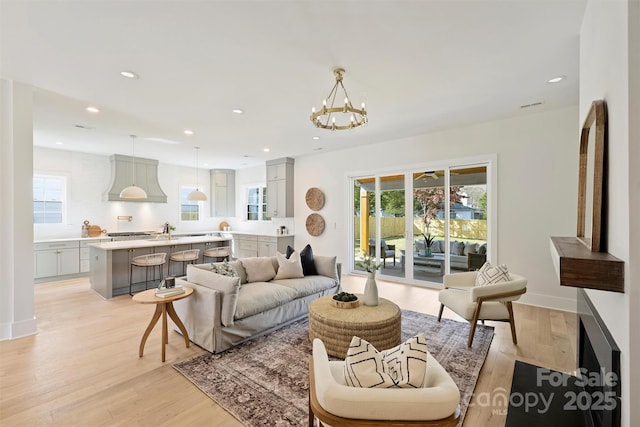 571 Lyttleton Dr, Charlotte, NC 28211 - living area with plenty of natural light, light wood-style floors, and a chandelier