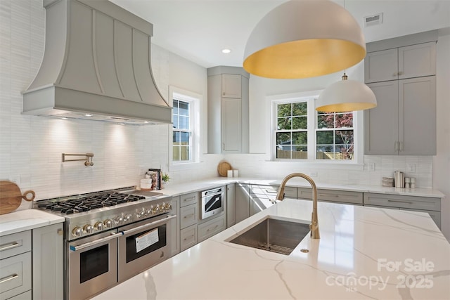 571 Lyttleton Dr, Charlotte, NC 28211 - kitchen with gray cabinets, range with two ovens, a sink, custom exhaust hood, and visible vents