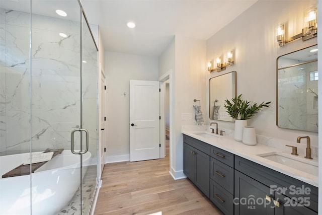 571 Lyttleton Dr, Charlotte, NC 28211 - full bath with double vanity, a sink, a marble finish shower, and wood finished floors
