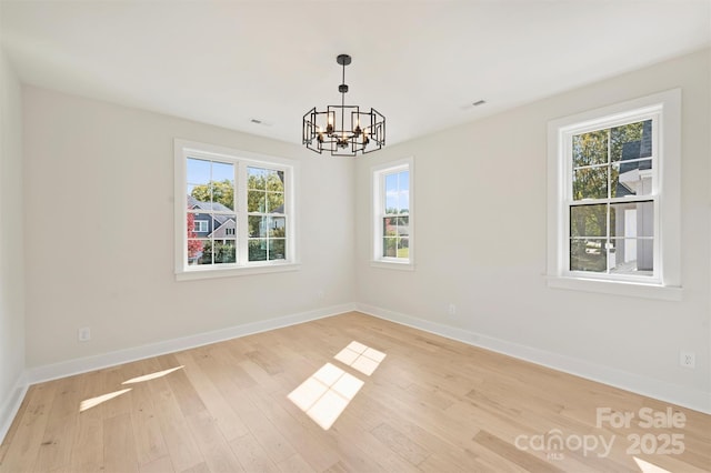 571 Lyttleton Dr, Charlotte, NC 28211 - unfurnished room featuring baseboards, visible vents, light wood-style flooring, and a chandelier