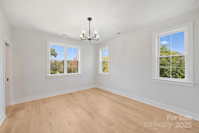 571 Lyttleton Dr, Charlotte, NC 28211 - spare room featuring baseboards, a notable chandelier, visible vents, and light wood-style flooring