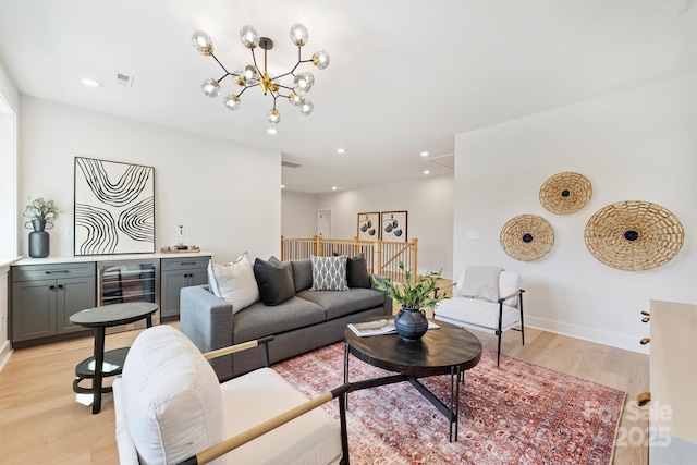 571 Lyttleton Dr, Charlotte, NC 28211 - living room featuring light wood-style flooring, visible vents, a bar, recessed lighting, and a notable chandelier