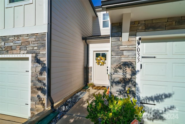 doorway to property featuring a garage