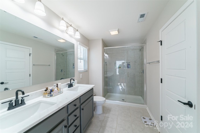 bathroom with toilet, an enclosed shower, vanity, and tile patterned floors