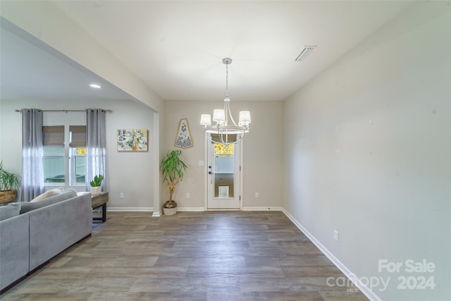 dining room with a notable chandelier and wood-type flooring