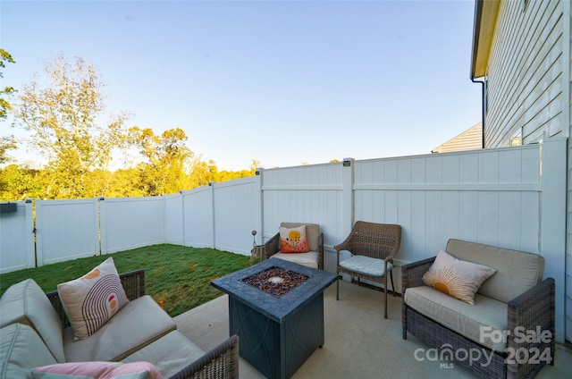 view of patio featuring an outdoor living space with a fire pit