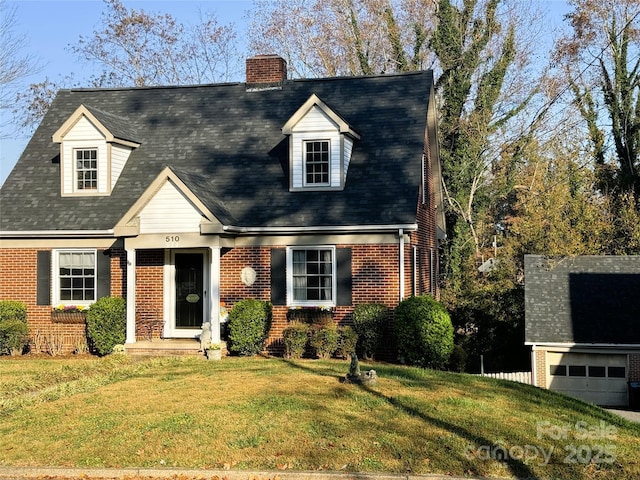 cape cod house featuring a garage and a front yard