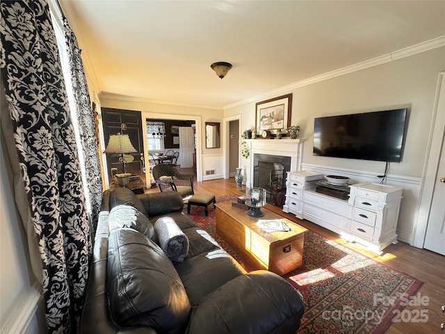 living room featuring wood-type flooring and ornamental molding