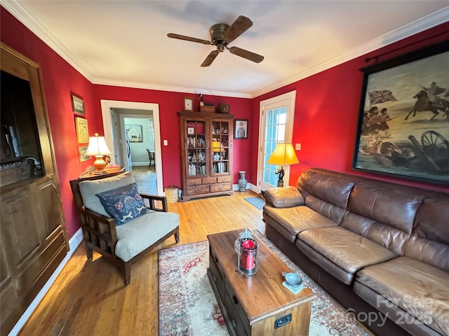 living room with crown molding, wood-type flooring, and ceiling fan