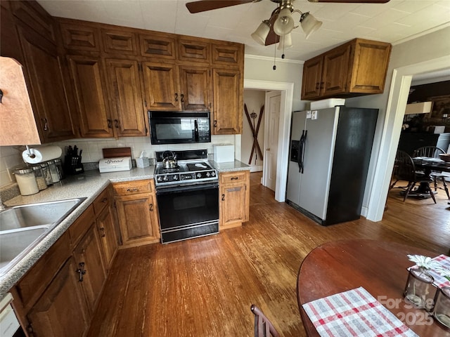 kitchen with tasteful backsplash, stove, ceiling fan, stainless steel fridge with ice dispenser, and dark wood-type flooring