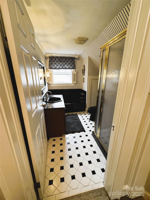 bathroom featuring walk in shower and vanity