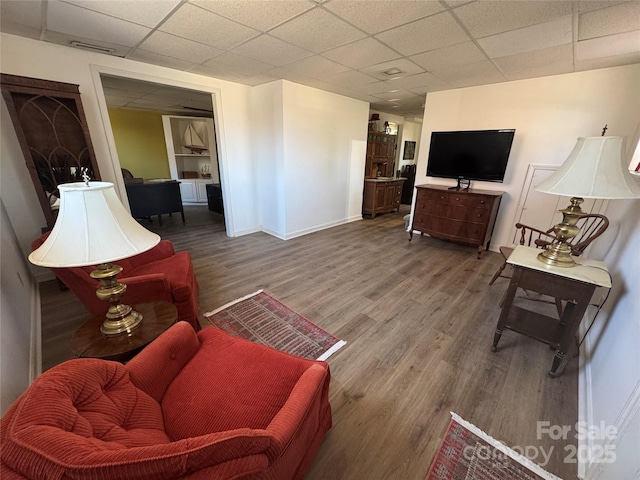 living room with hardwood / wood-style flooring and a drop ceiling