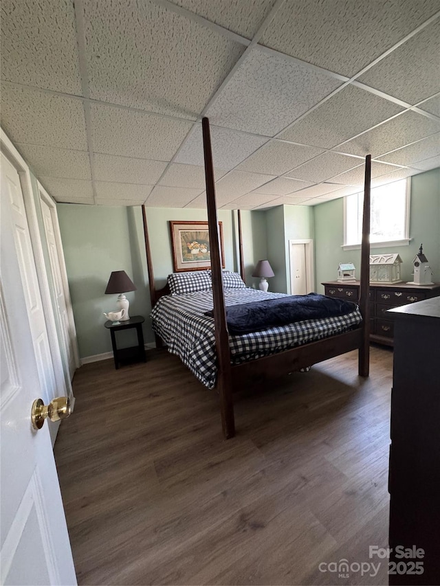 bedroom featuring hardwood / wood-style floors and a paneled ceiling