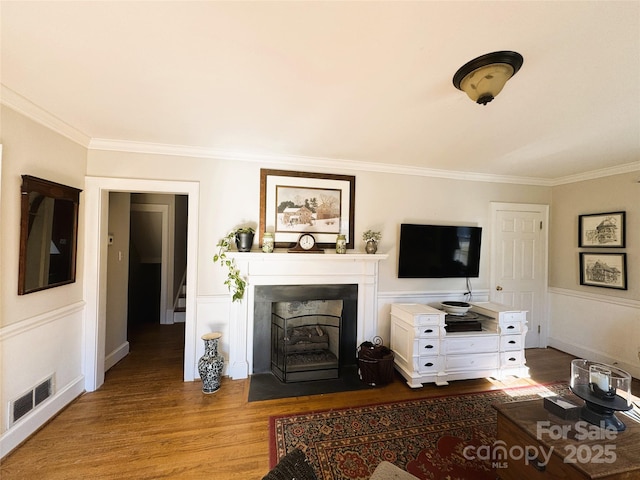 living room with hardwood / wood-style flooring and ornamental molding