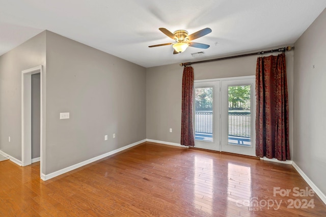 unfurnished room with ceiling fan and hardwood / wood-style floors