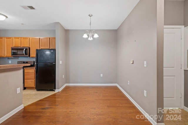 kitchen with stainless steel appliances, pendant lighting, light hardwood / wood-style flooring, light brown cabinets, and an inviting chandelier