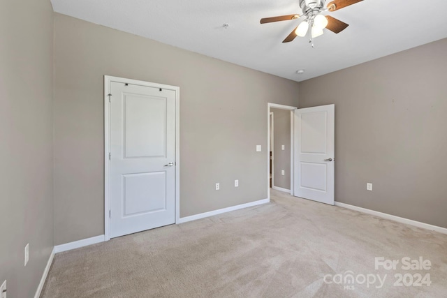 unfurnished bedroom featuring ceiling fan and light carpet