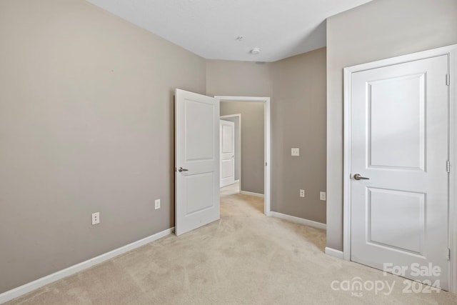 unfurnished bedroom with light carpet