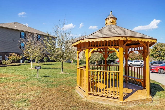 view of home's community with a yard, a gazebo, and a wooden deck