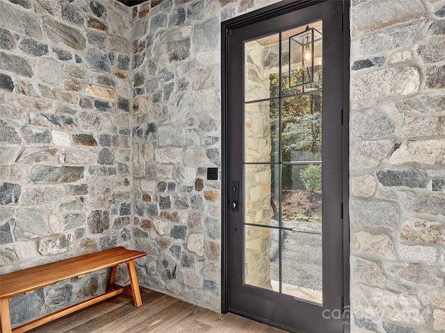 doorway with hardwood / wood-style floors